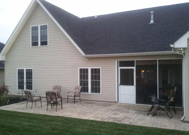 a view of a house with patio and a yard