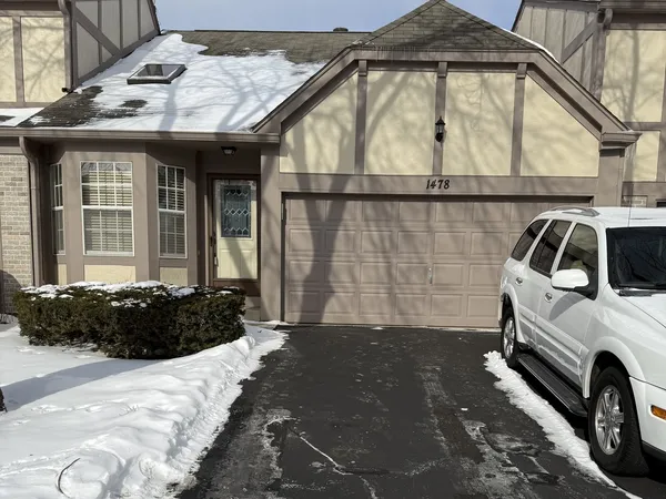 a view of a car parked front of a house