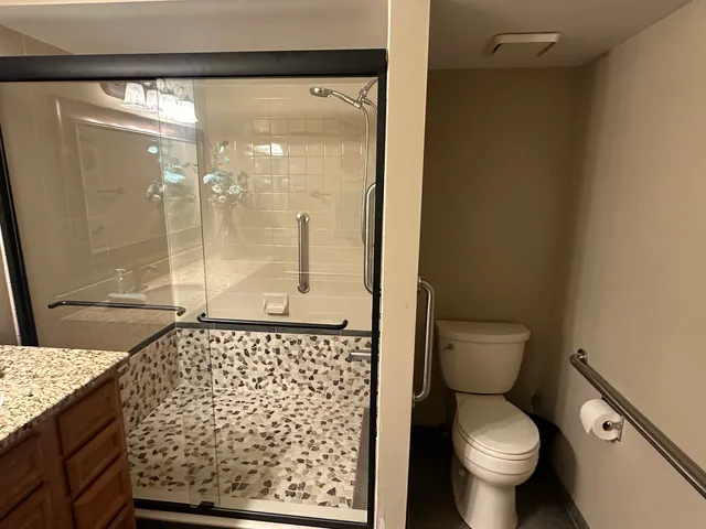 a living room with furniture a rug and a lamp