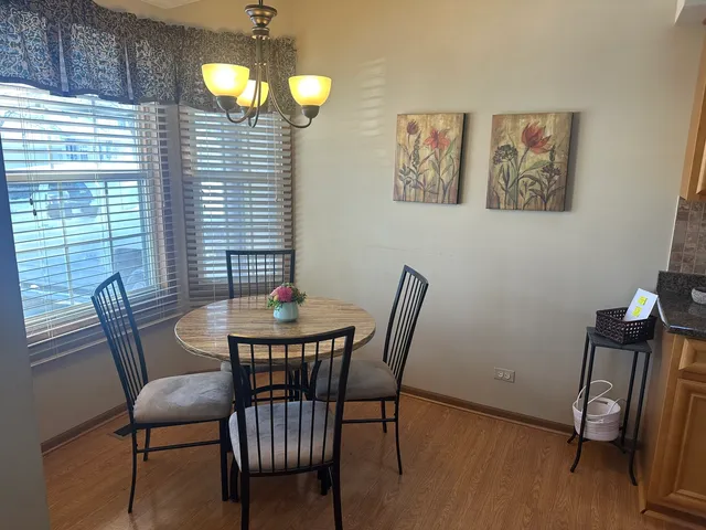 a kitchen with table chairs refrigerator and stove