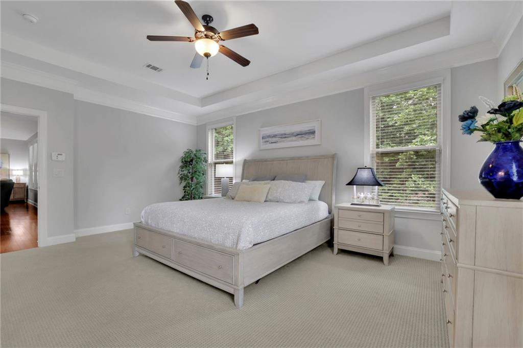 6255 Allison Road Cumming, GA 30040 - Photo 18 of 36 a bedroom with a bed and a chandelier