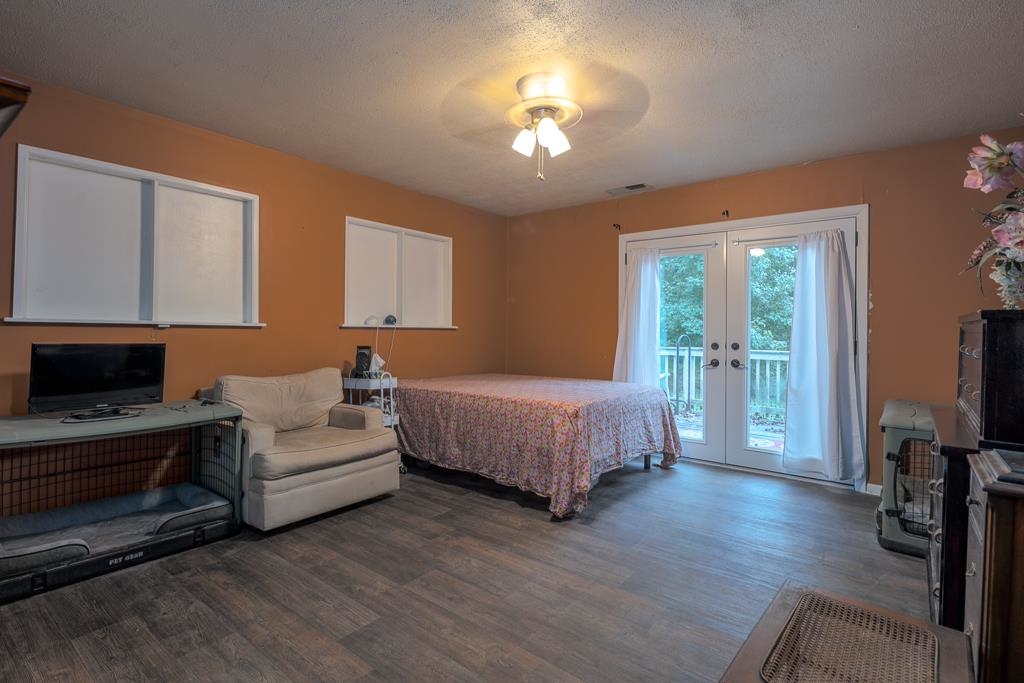4036 Shelby Road Millington, TN 38053 - Photo 14 of 26 a spacious bedroom with a bed and a flat tv screen on dresser