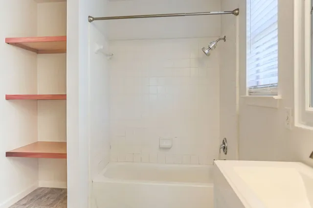 a bathroom with a bathtub and a shower