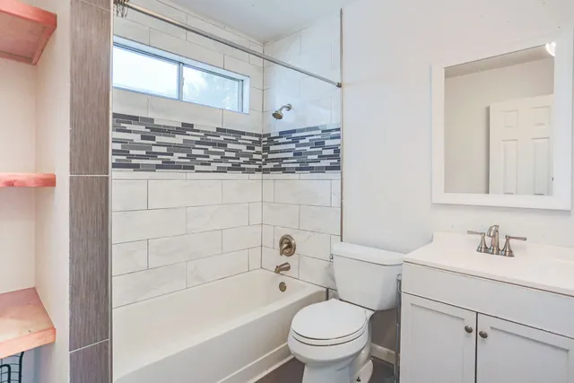 a bathroom with a bathtub toilet and sink