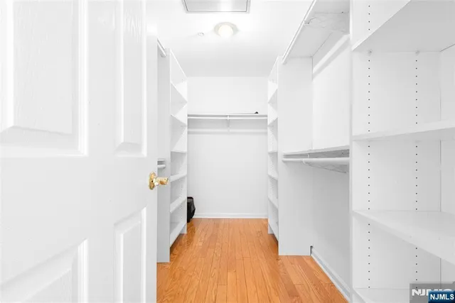 a view of hallway with wooden floor