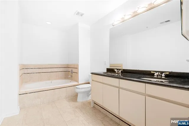 a bathroom with a toilet a sink and vanity