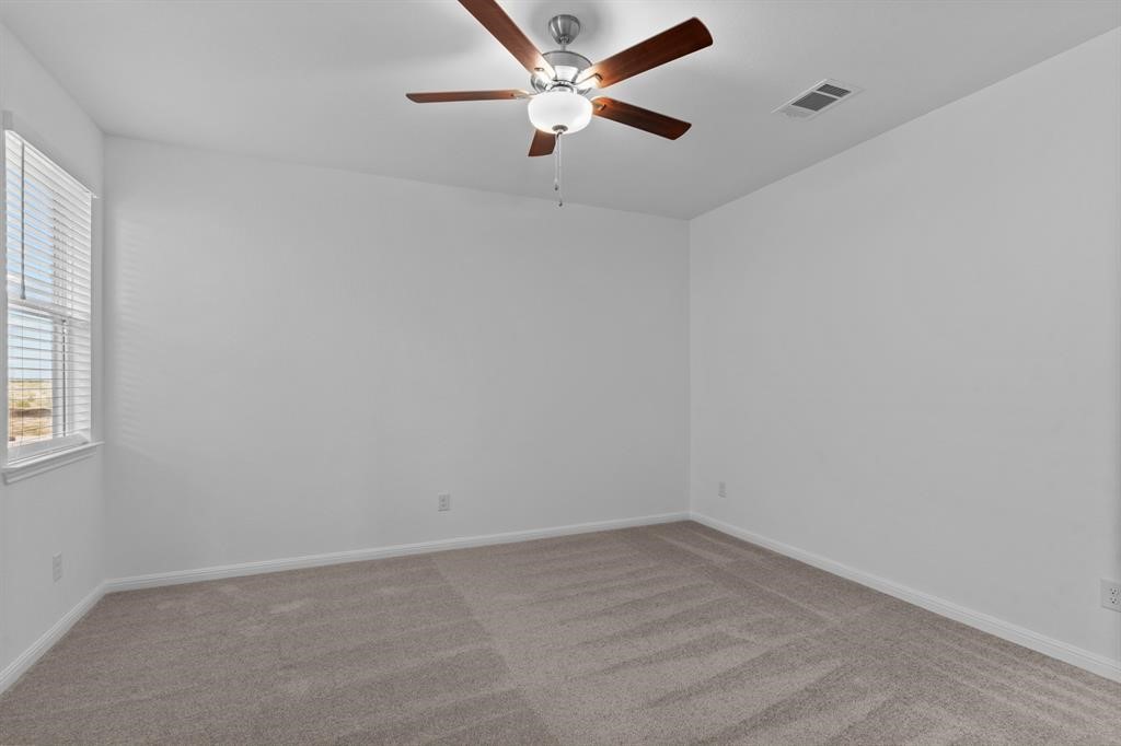 1018 Vanderscile Road Hutto, TX 78634 - Photo 15 of 27 an empty room with a window and a fan