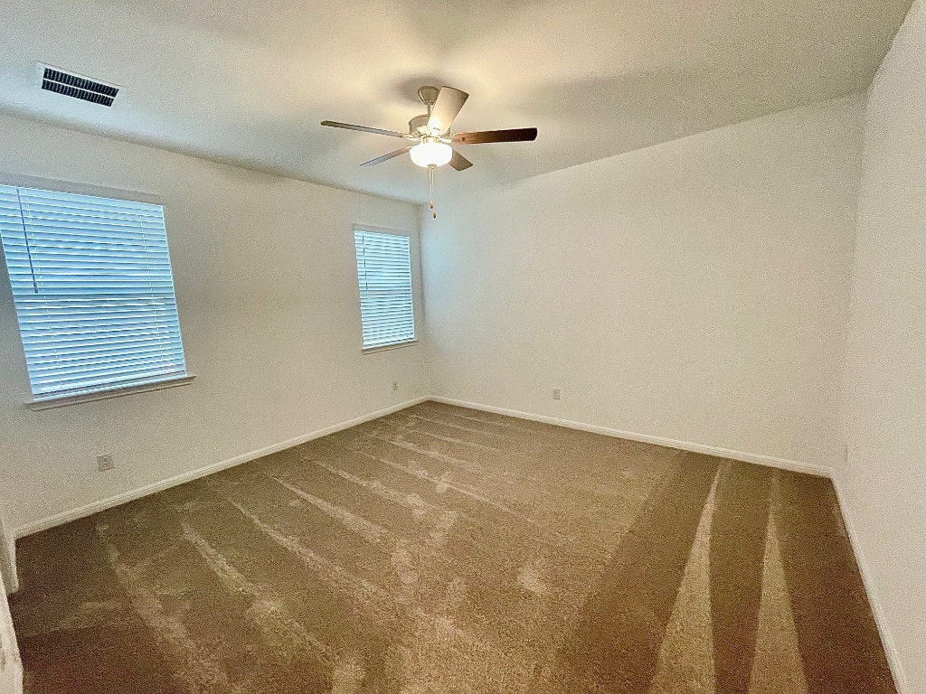 1018 Vanderscile Road Hutto, TX 78634 - Photo 6 of 27 a view of an empty room with a chandelier fan