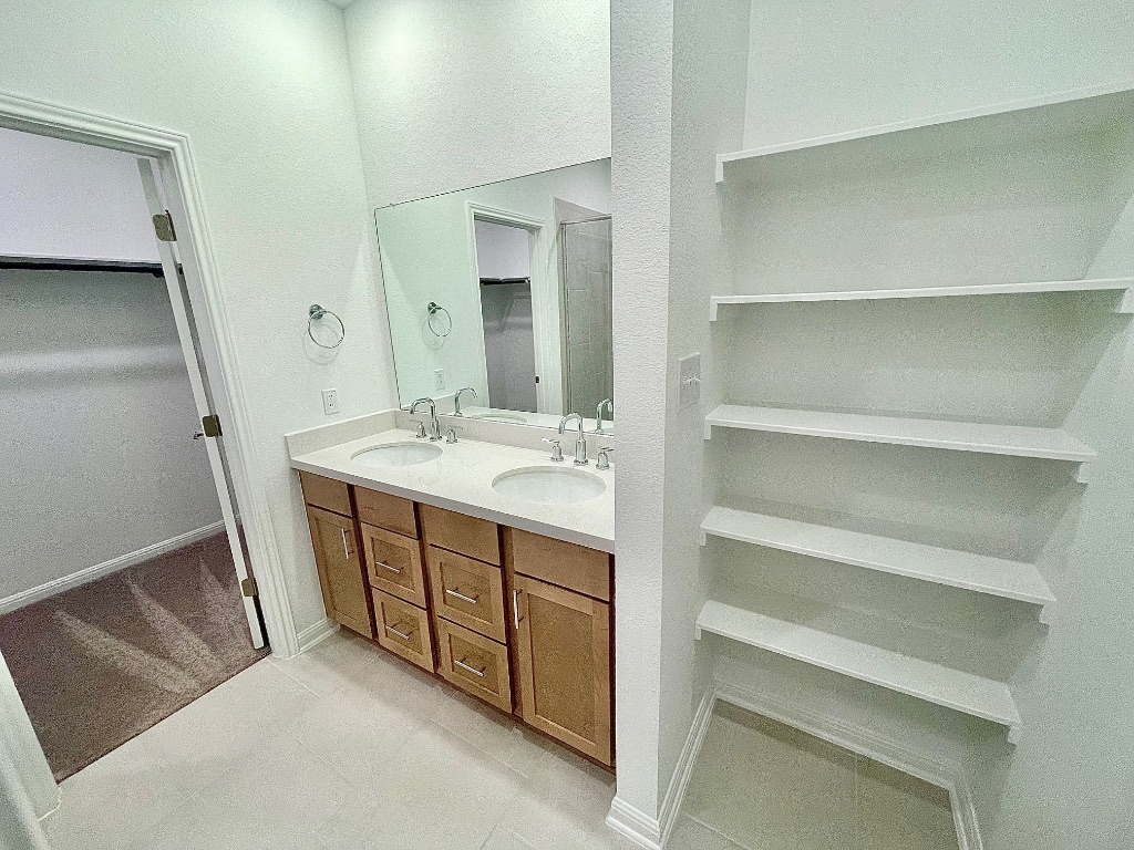 1018 Vanderscile Road Hutto, TX 78634 - Photo 8 of 27 a bathroom with a sink a vanity and a mirror