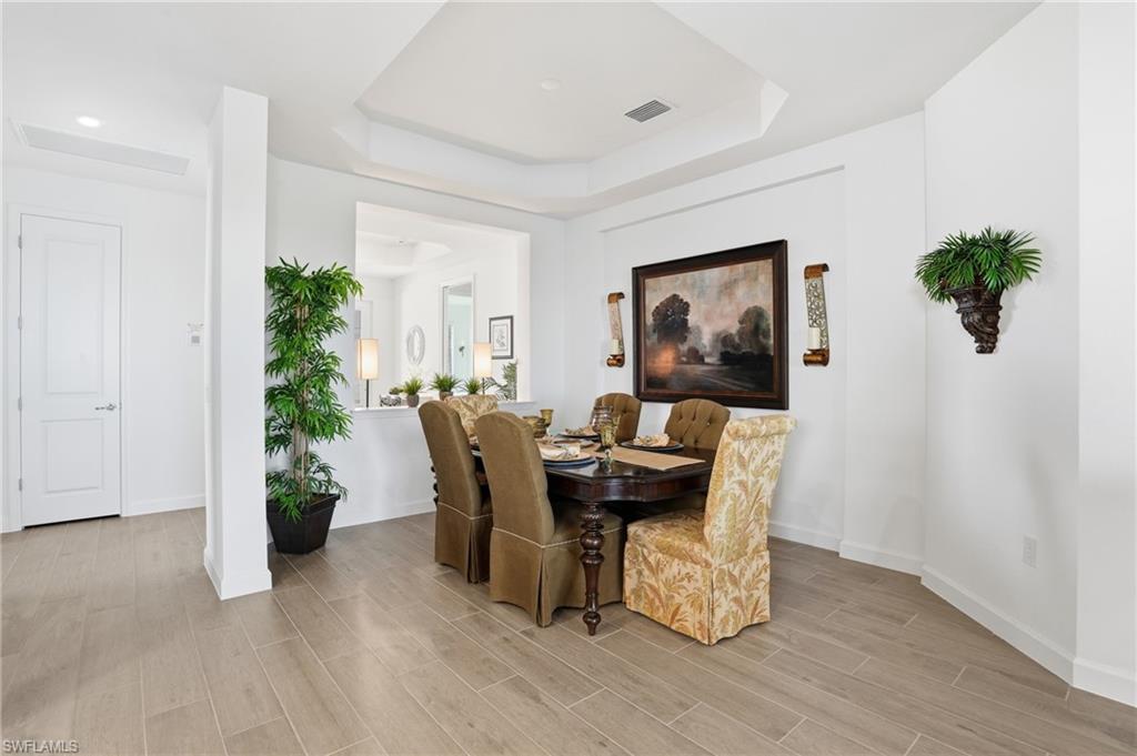 44481 Mesquite Lane Babcock Ranch, FL 33982 - Photo 12 of 34 a dining room with furniture and wooden floor