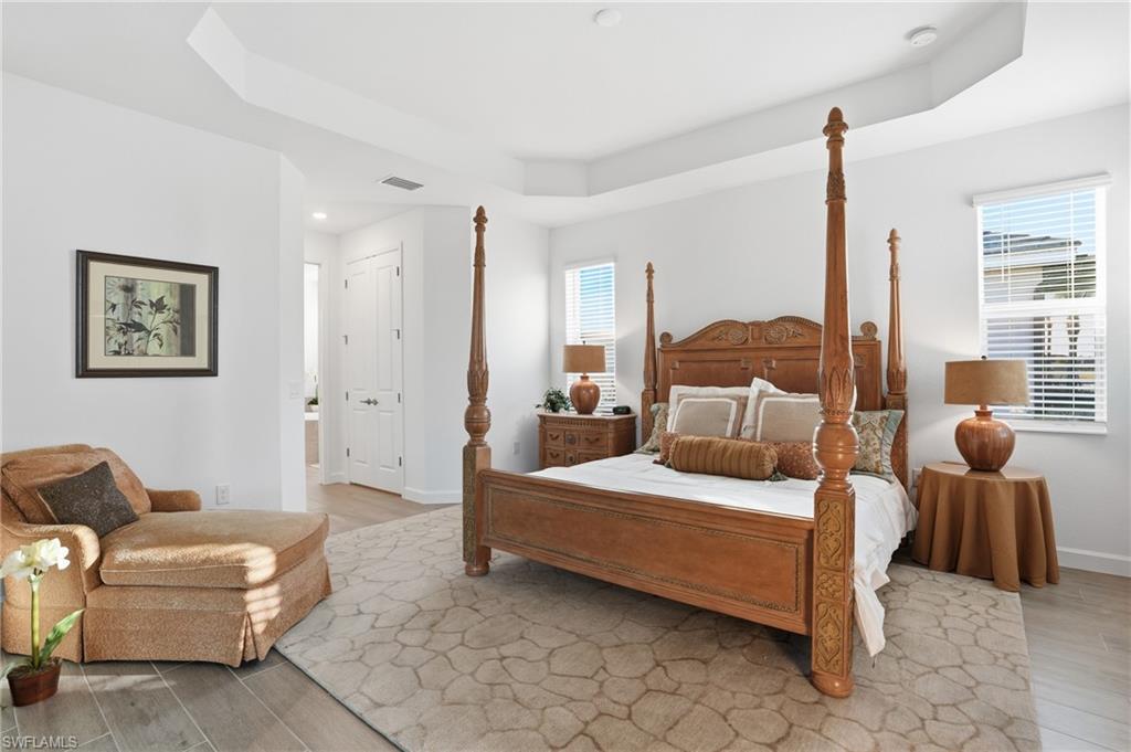 44481 Mesquite Lane Babcock Ranch, FL 33982 - Photo 19 of 34 a bedroom with a bed and glass window