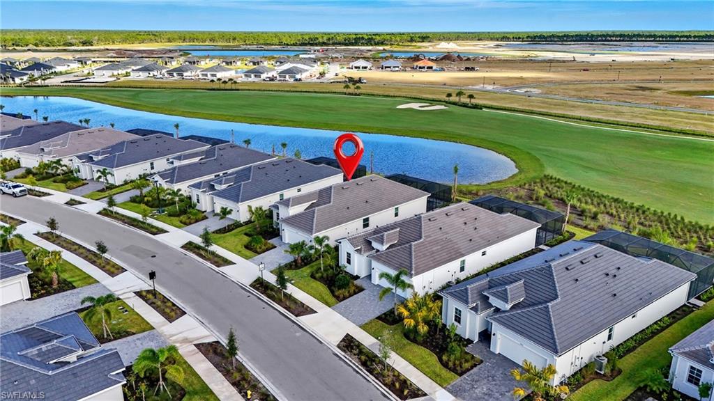 44481 Mesquite Lane Babcock Ranch, FL 33982 - Photo 2 of 34 an aerial view of a house with a garden and lake view