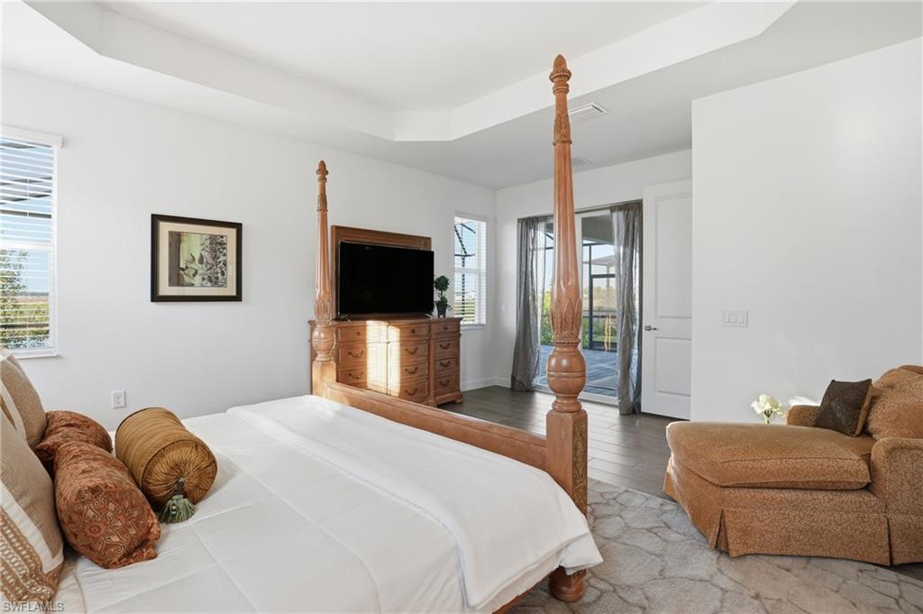 44481 Mesquite Lane Babcock Ranch, FL 33982 - Photo 21 of 34 a bedroom with a bed flat screen tv and a couch