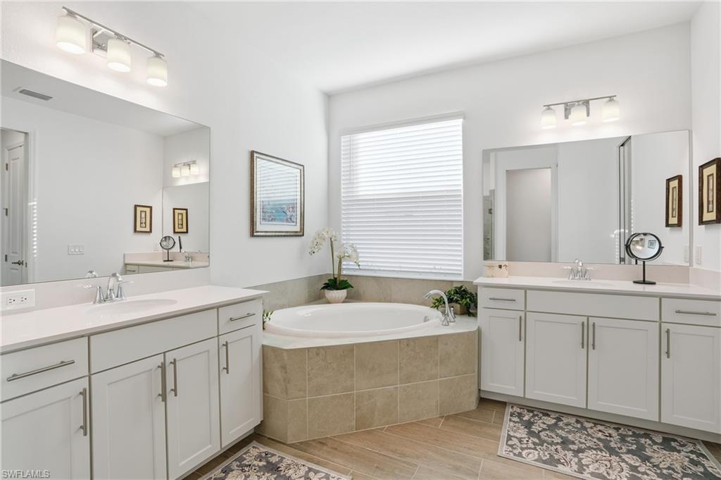 44481 Mesquite Lane Babcock Ranch, FL 33982 - Photo 22 of 34 a bathroom with a double vanity sink mirror and bathtub