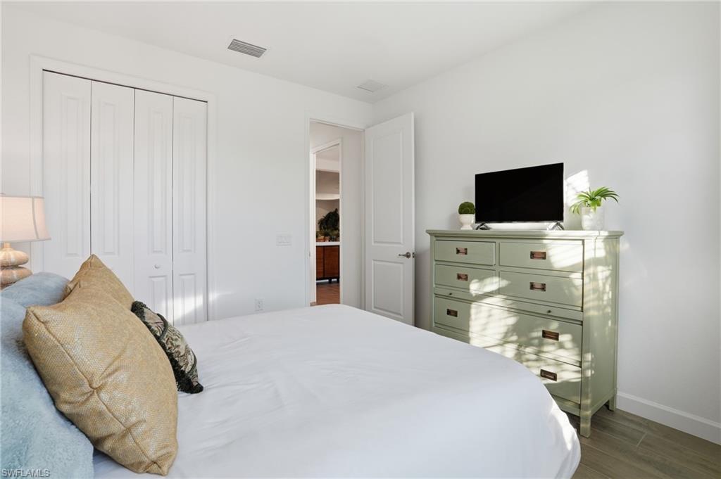 44481 Mesquite Lane Babcock Ranch, FL 33982 - Photo 26 of 34 a bedroom with a bed and a flat screen tv