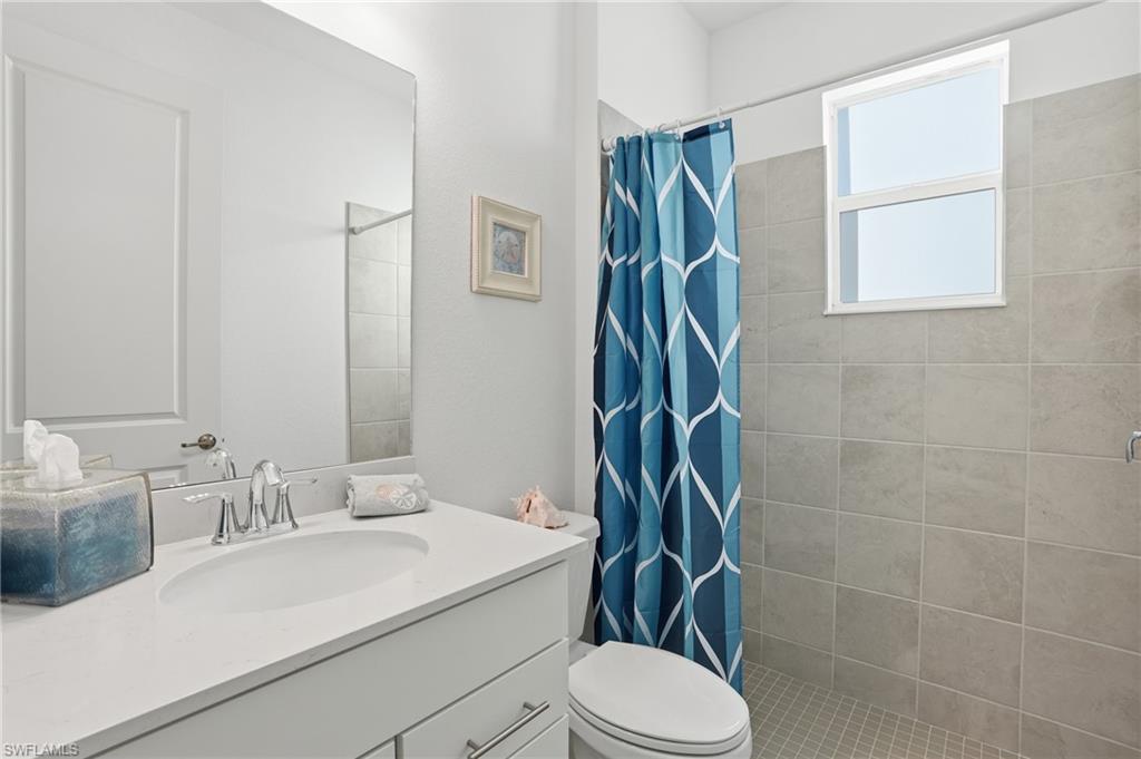 44481 Mesquite Lane Babcock Ranch, FL 33982 - Photo 27 of 34 a bathroom with a sink toilet and shower