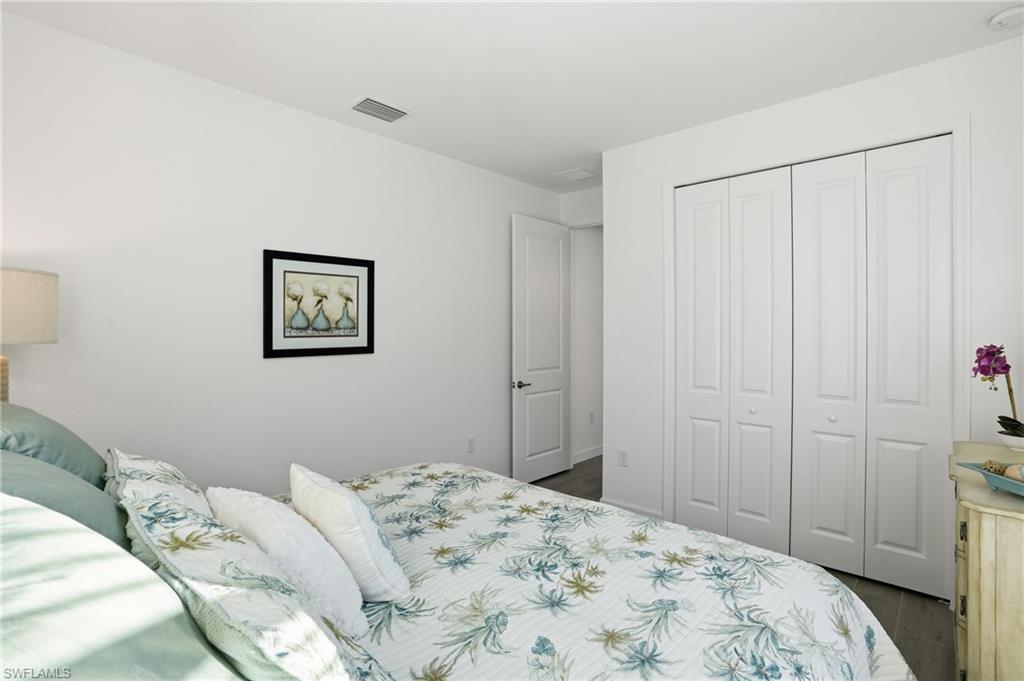 44481 Mesquite Lane Babcock Ranch, FL 33982 - Photo 29 of 34 a bedroom with a bed and a closet