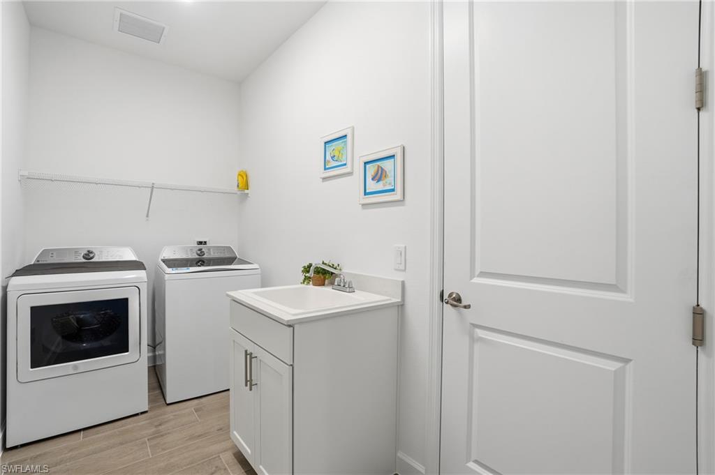 44481 Mesquite Lane Babcock Ranch, FL 33982 - Photo 30 of 34 a utility room with dryer and washer