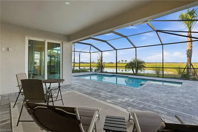 a dining room with furniture and a floor to ceiling window