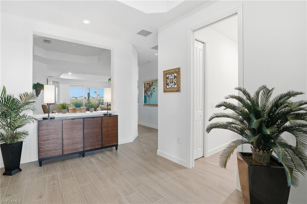 44481 Mesquite Lane Babcock Ranch, FL 33982 - Photo 6 of 34 a view of a kitchen and an entryway with wooden floor