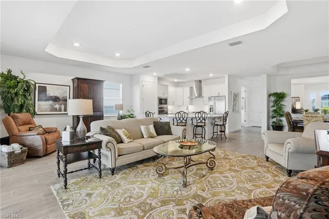 a living room with furniture and a view of kitchen
