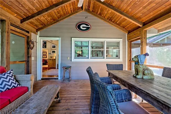 a living room with furniture a large window with backyard view