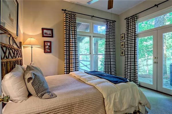 a bedroom with a bed next to a window