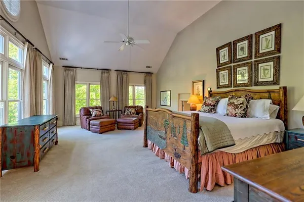 a spacious bathroom with a granite countertop double vanity sink a mirror and a shower