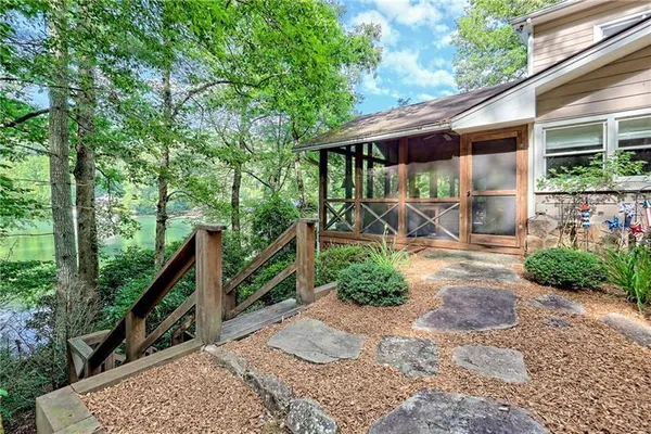 a view of a patio with chairs next to a yard