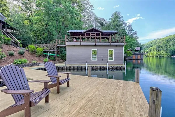 a view of a house with a yard from a lake view