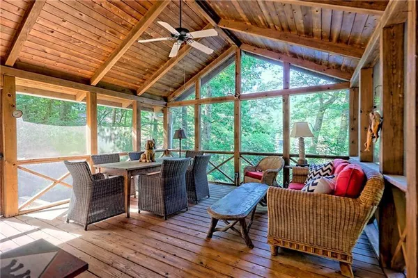 a living room with furniture a wooden floor and next to a window