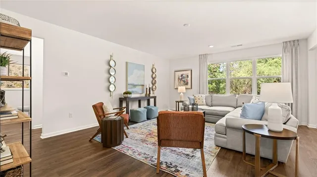 a spacious bedroom with furniture and a large window