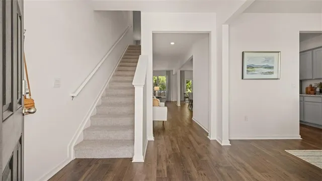 a view of a dining room with furniture and wooden floor