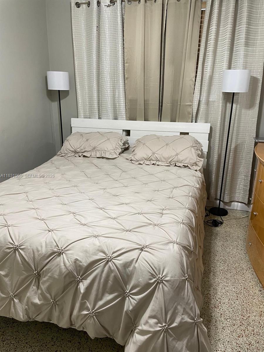 266 East 12th Street Hialeah, FL 33010 - Photo 11 of 19 a bedroom with a bed and a couch