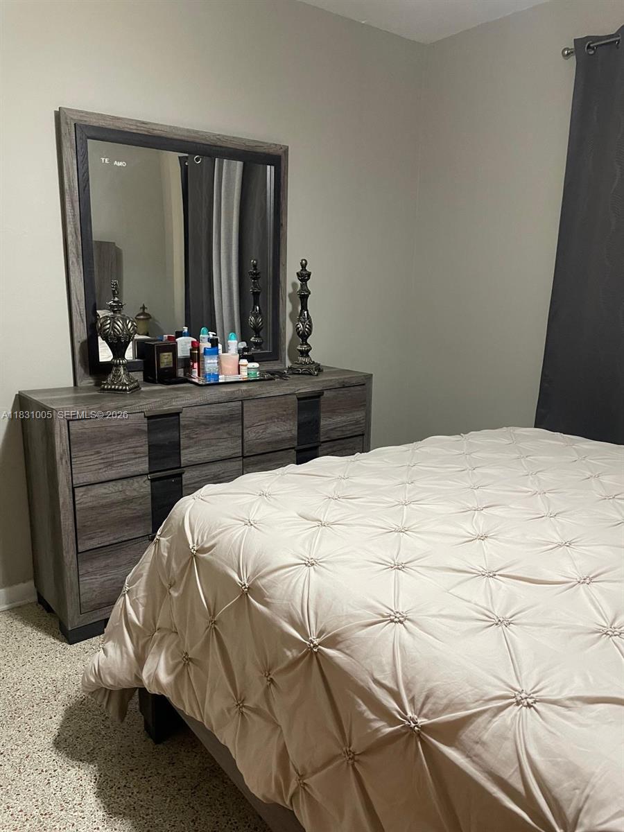266 East 12th Street Hialeah, FL 33010 - Photo 13 of 19 a bedroom with a bed window and mirror