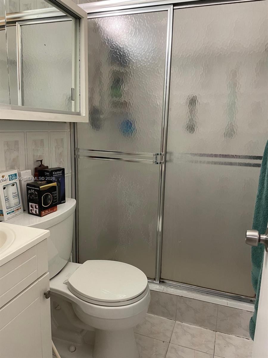 266 East 12th Street Hialeah, FL 33010 - Photo 16 of 19 a bathroom with a toilet a sink and shower