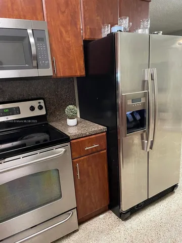 a close view of a stove and refrigerator