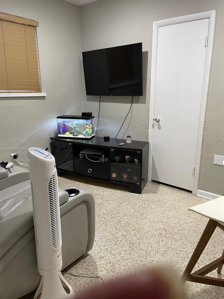 266 East 12th Street Hialeah, FL 33010 - Photo 9 of 19 a living room with furniture and a flat screen tv