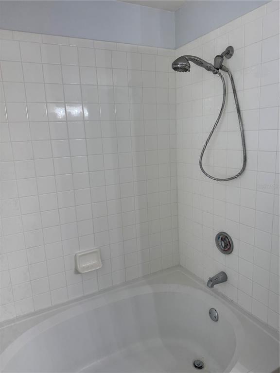 416 Summit Ridge Place, Unit 316 Longwood, FL 32779 - Photo 14 of 24 a bathroom with a bath tub with a shower