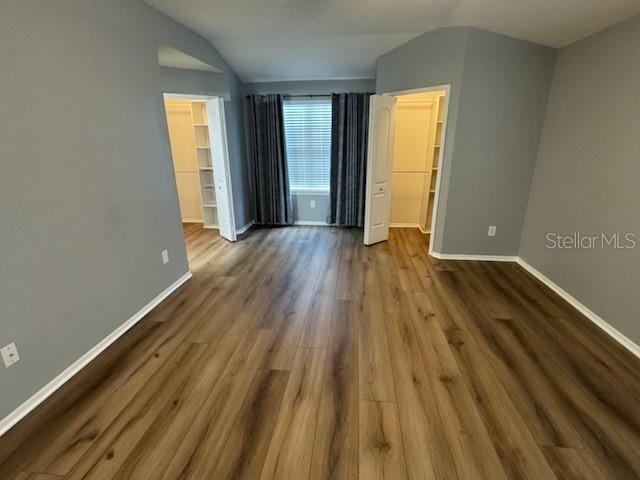 416 Summit Ridge Place, Unit 316 Longwood, FL 32779 - Photo 18 of 24 a view of an empty room with wooden floor and a window
