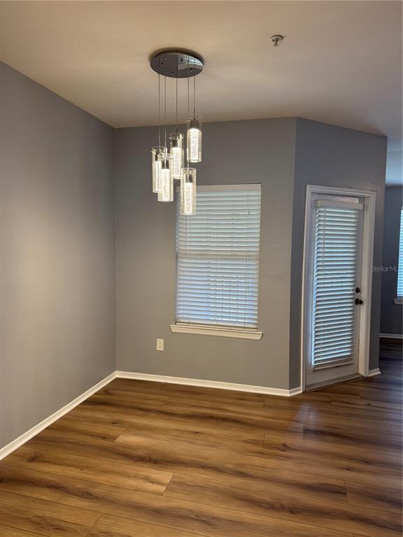 416 Summit Ridge Place, Unit 316 Longwood, FL 32779 - Photo 2 of 24 a view of empty room with wooden floor chandelier and window