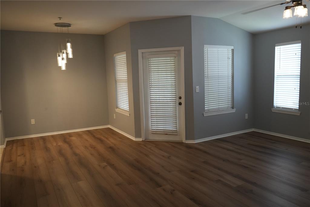 416 Summit Ridge Place, Unit 316 Longwood, FL 32779 - Photo 4 of 24 an empty room with wooden floor cabinet and windows
