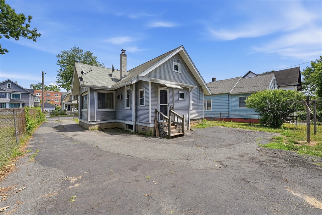 136 Maynard Street Springfield, MA 01109 - Photo 33 of 35 a view of a house with a patio and a yard