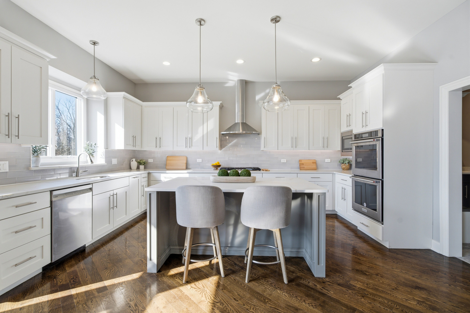 28 Pinnacle Court Naperville, IL 60565 - Photo 2 of 40 a kitchen with a dining table chairs wooden floor cabinets and appliances