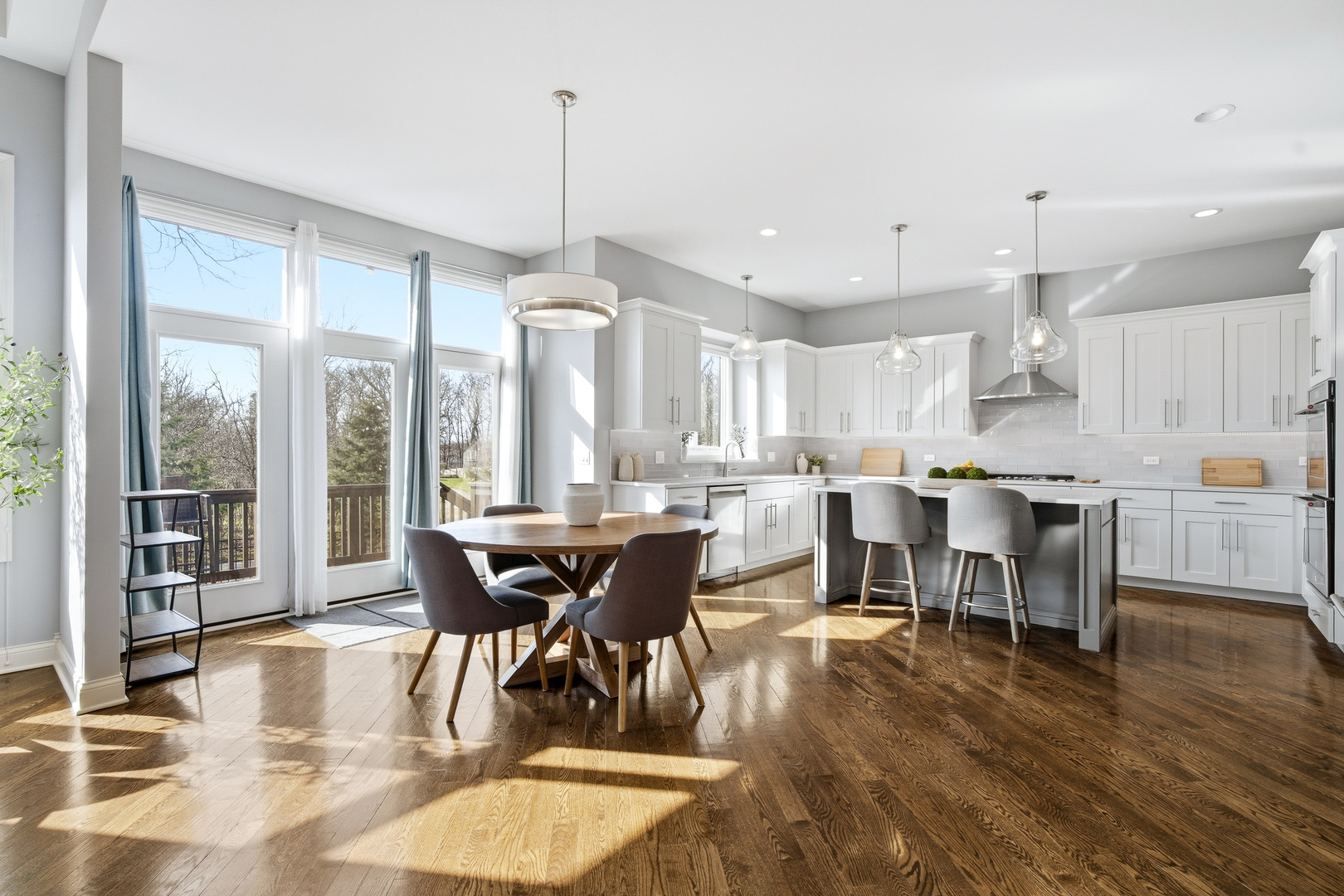 28 Pinnacle Court Naperville, IL 60565 - Photo 4 of 40 a view of a dining room and livingroom with furniture wooden floor a chandelier