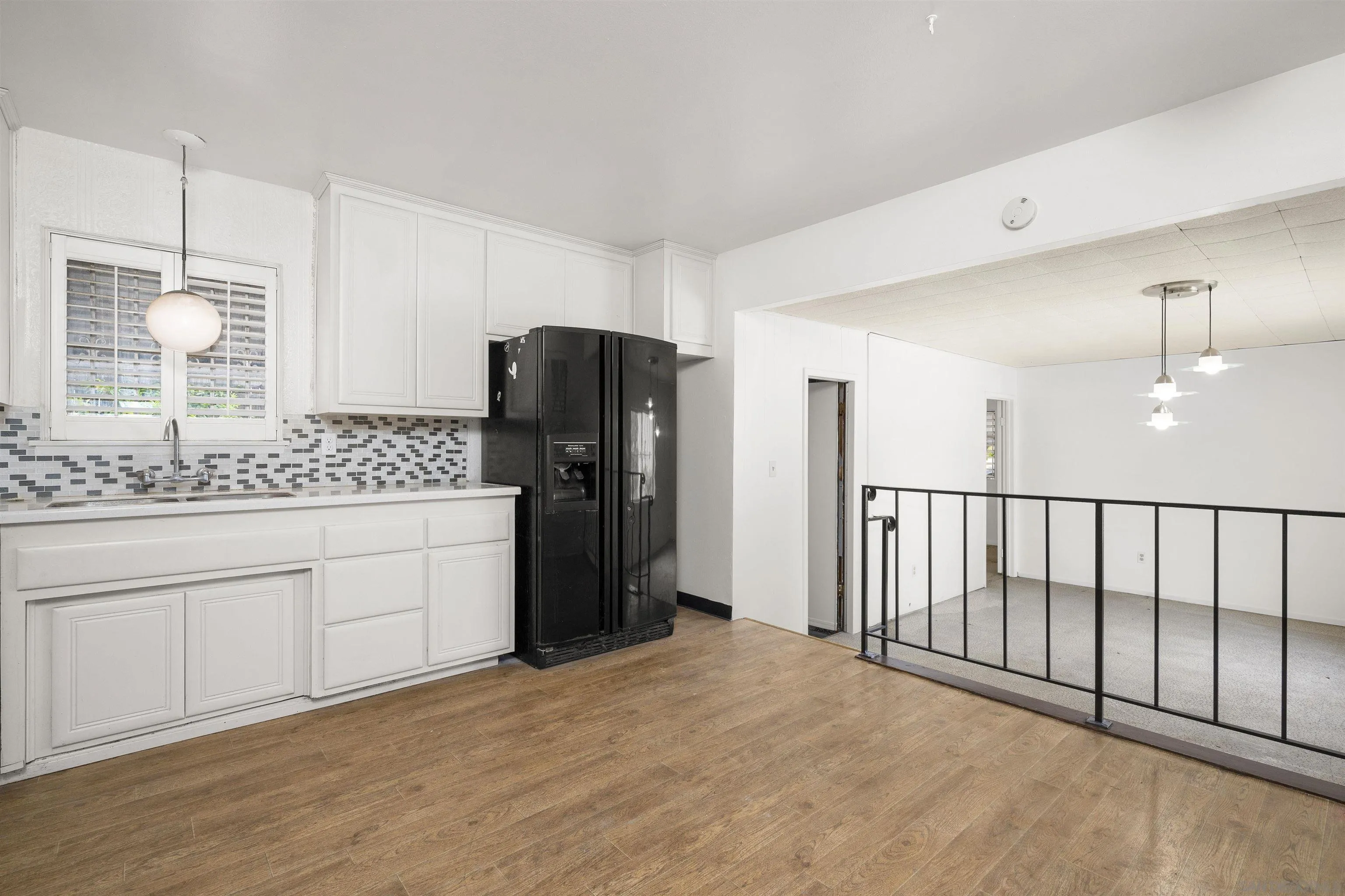 a kitchen with a refrigerator and a sink