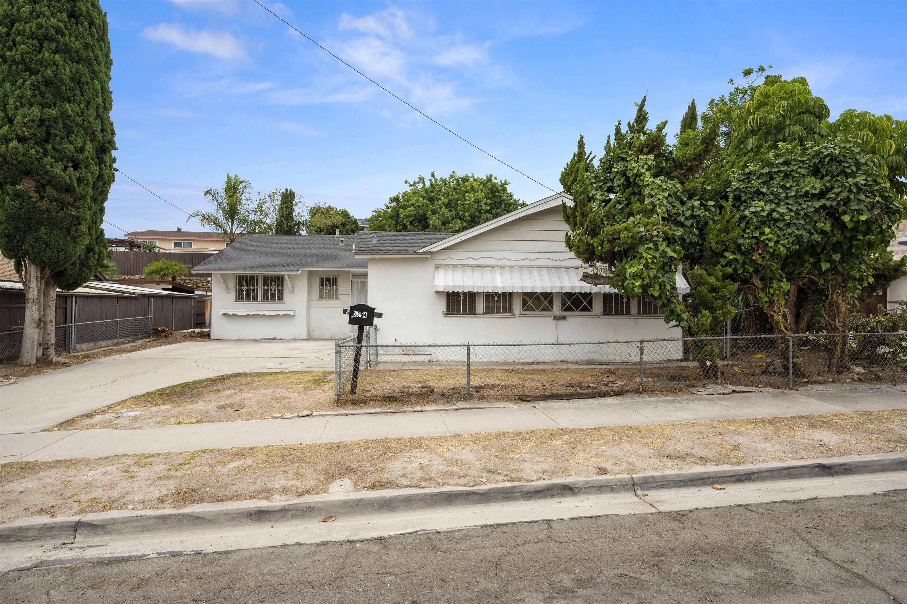 2854 Rhoades Road San Diego, CA 92139 - Photo 2 of 10 a front view of a house with a garden