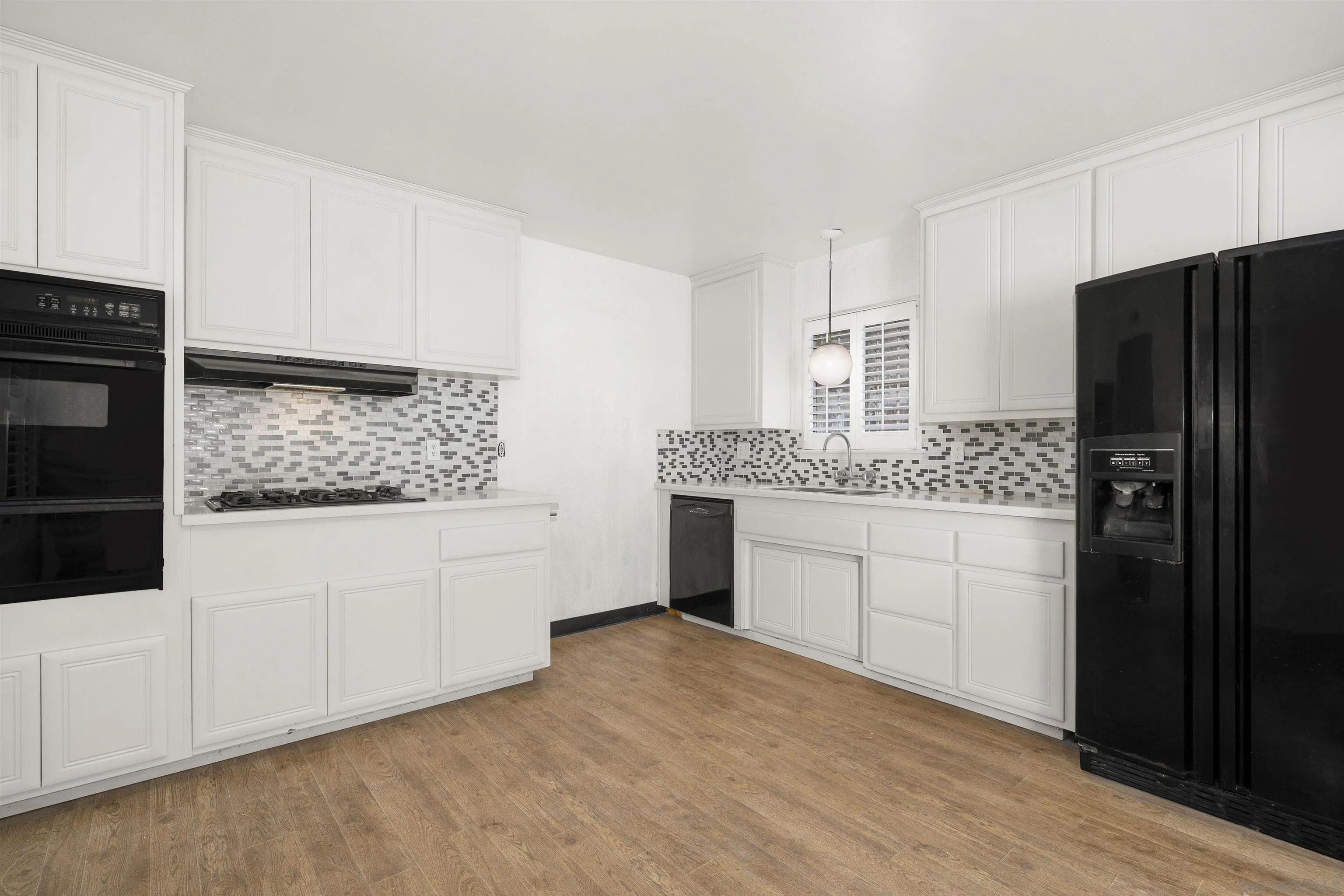2854 Rhoades Road San Diego, CA 92139 - Photo 4 of 10 a kitchen with granite countertop white cabinets and stainless steel appliances