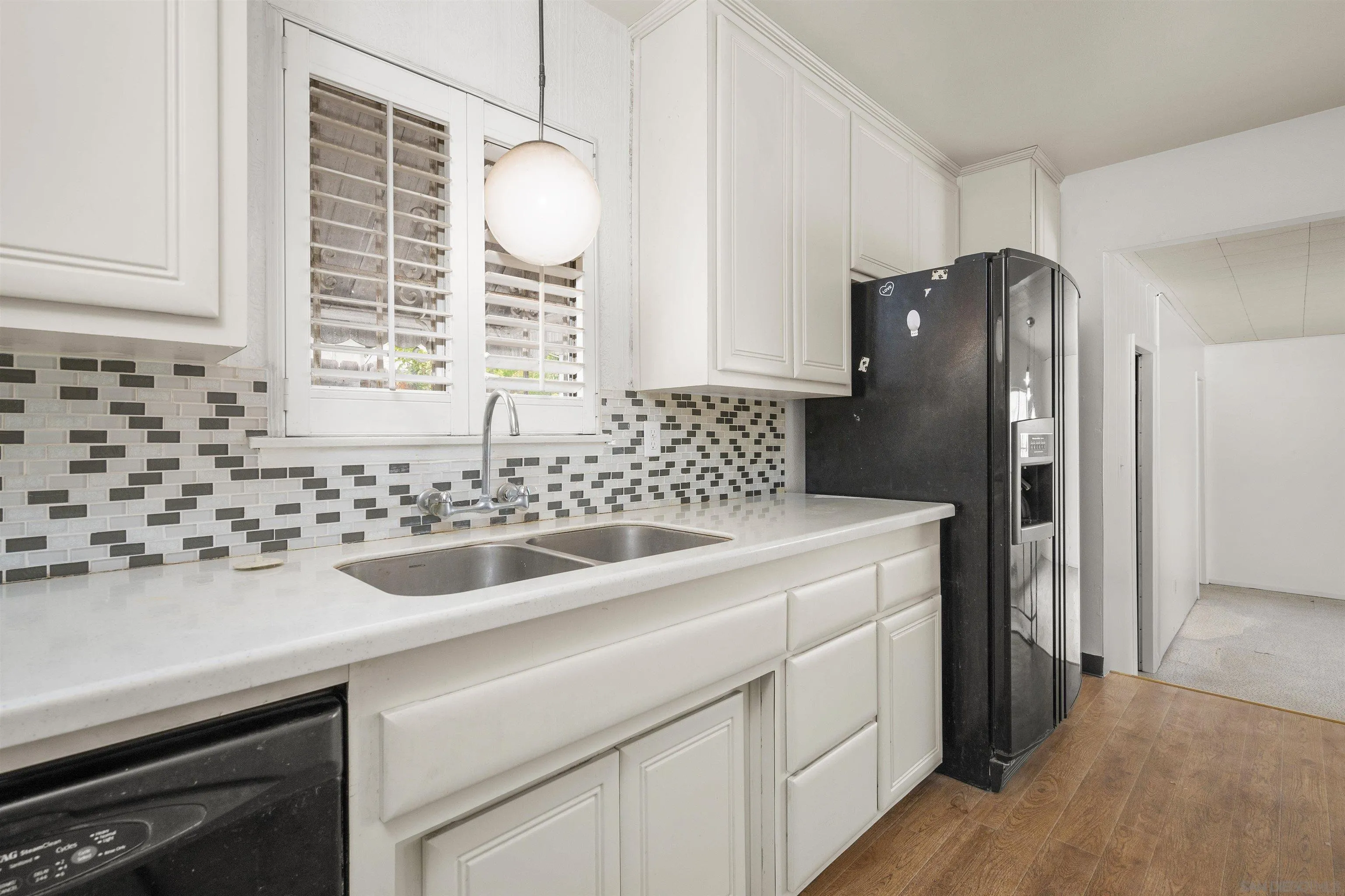 2854 Rhoades Road San Diego, CA 92139 - Photo 5 of 10 a kitchen with a sink and a refrigerator