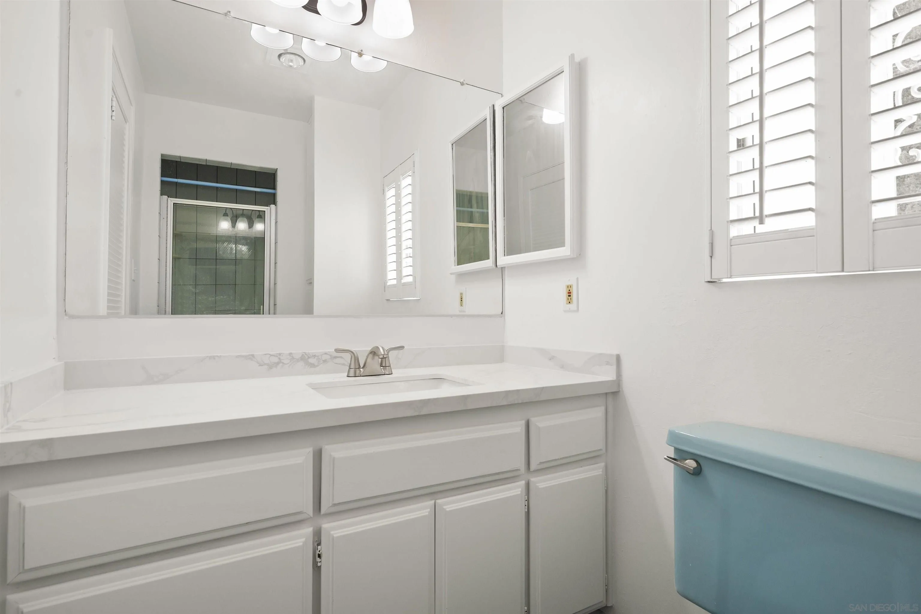 2854 Rhoades Road San Diego, CA 92139 - Photo 8 of 10 a bathroom with a sink and a mirror
